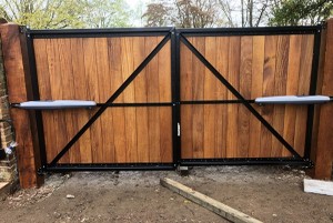 Metal framed gate with above ground motors